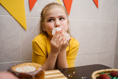 Girl wipes her mouth with a napkin after a festive dinner