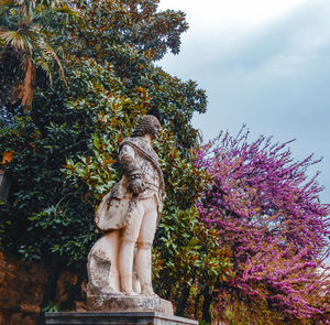 Low angle view of statue against trees in park