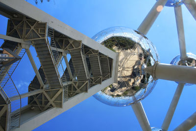 Low angle view of metallic structure against blue sky