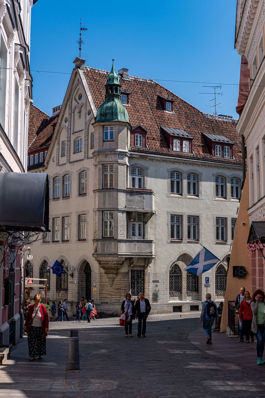 architecture, building exterior, built structure, group of people, building, real people, city, crowd, women, large group of people, sky, day, window, adult, lifestyles, clear sky, nature, men, town, outdoors