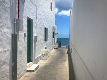 Alley amidst buildings against sky