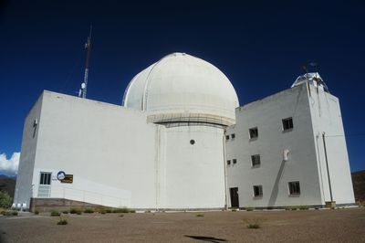 Low angle view of building against clear blue sky