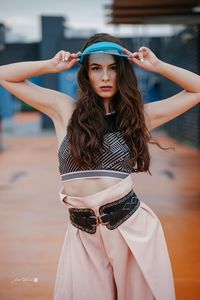 Portrait of beautiful young woman standing outdoors