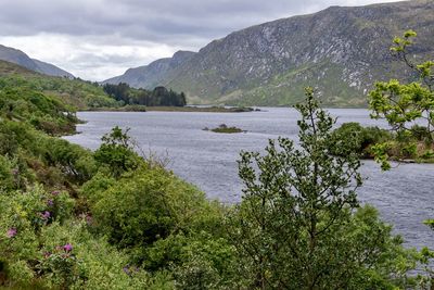 Scenic view of lake and mountains against sky