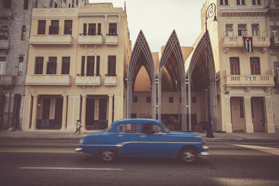 Cars on street in front of historic building