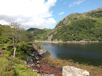 Scenic view of lake against cloudy sky