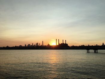 Silhouette of city at waterfront