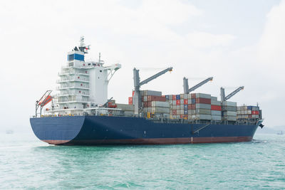 Ship sailing in sea against sky