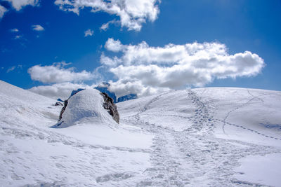 Snow covered landscape against sky