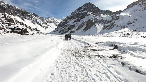 Person walking on snow covered mountain