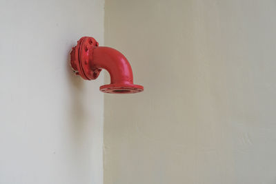 Close-up of red bell on white background