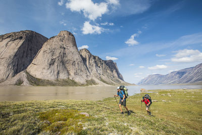 People on mountain against sky