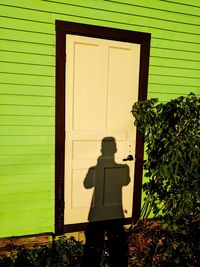 Shadow of person on door of house