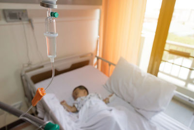High angle view of baby boy lying on bed in hospital