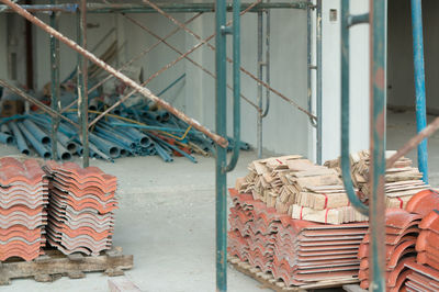 Stack of rusty metal by building