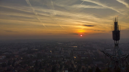 Aerial view of buildings against sky during sunset