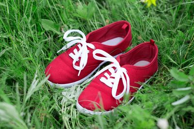 Close-up of red shoes on field