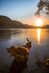 Scenic view of lake against sky during sunset