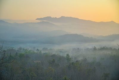 Scenic view of landscape against sky at sunset