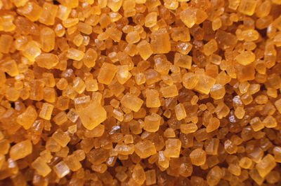 Extreme macro. sugar crystals. close-up of brown cane sugar on a plane. texture or background of