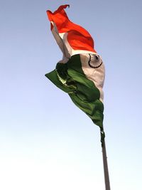 Low angle view of indian flag waving against clear sky