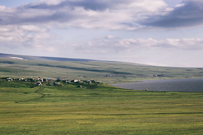 Scenic view of agricultural field against sky