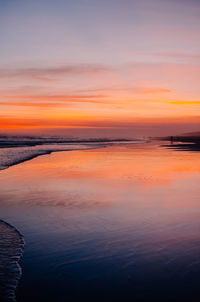 Scenic view of sea against romantic sky at sunset