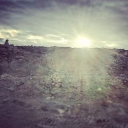 Scenic view of landscape against cloudy sky