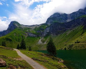 Scenic view of lake and mountains against sky