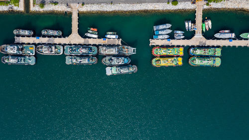 Directly above view of boats moored at pier in harbor