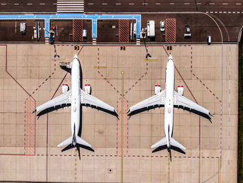 Directly above shot of airplane on airport runway