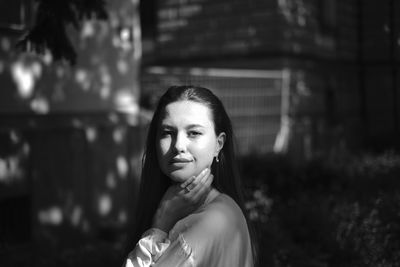 Portrait of beautiful young woman standing outdoors