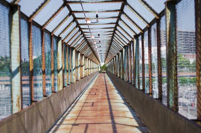 Narrow footbridge along railings