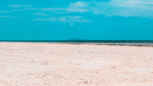 Scenic view of beach against blue sky