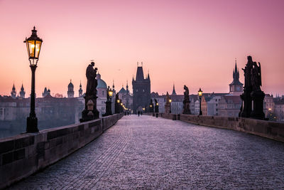 View of bridge and buildings against sky during sunrise. prague charles bridge