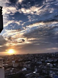 Aerial view of cityscape against sky during sunset