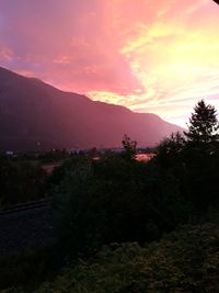 Scenic view of mountains against sky at sunset