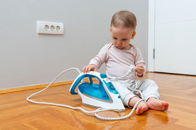 Portrait of cute baby boy sitting on table