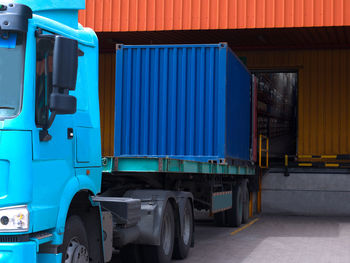 Truck unloading against warehouse