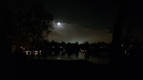 Illuminated landscape against sky at night