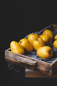 Close-up of yellow fruits against black background
