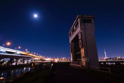 Illuminated bridge at night