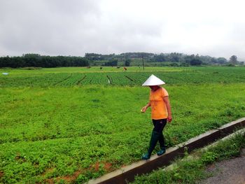 Man working on field against sky