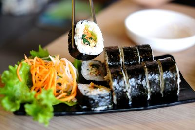 High angle view of sushi in plate on wooden table