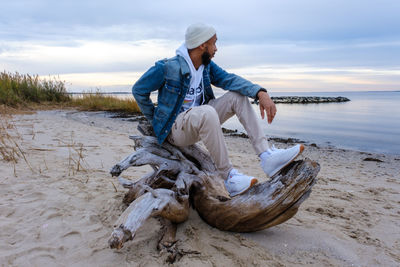 Side view of man posing at the beach