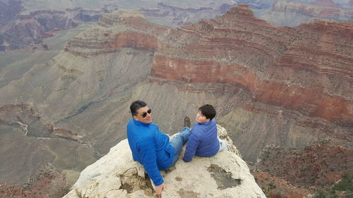 High angle view of father and son at grand canyon