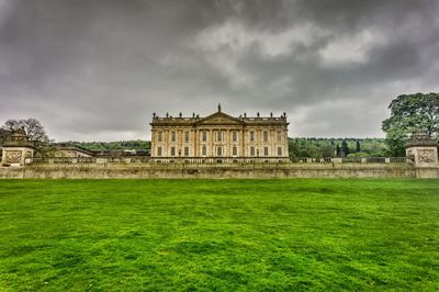 Low angle view of historical building against cloudy sky