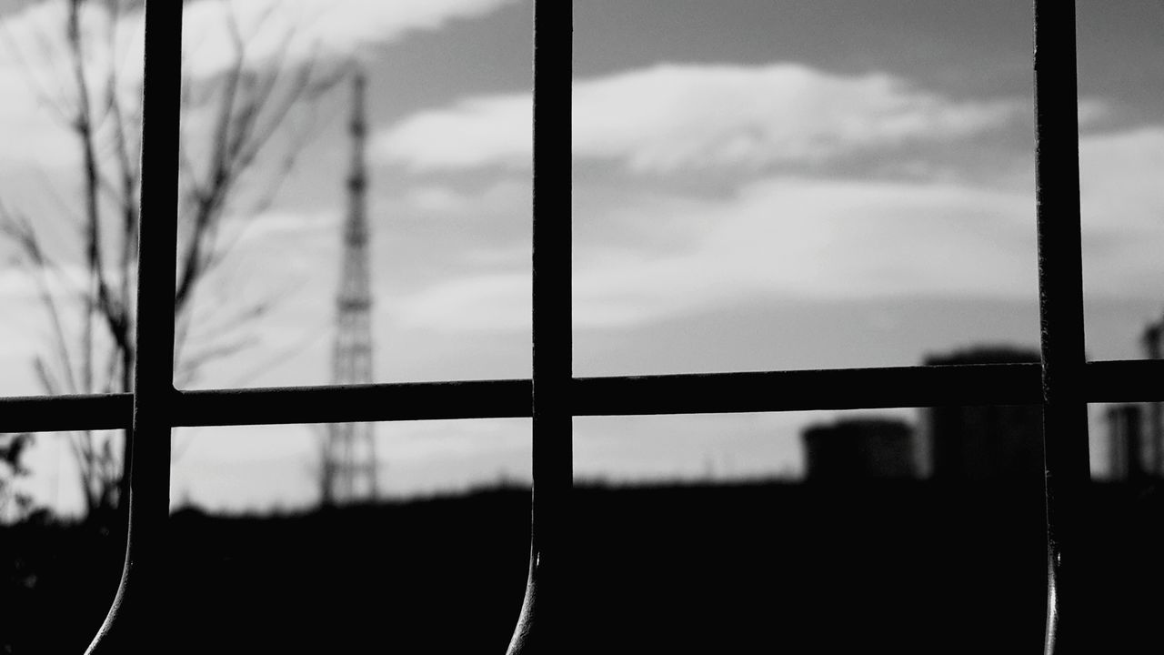 window, indoors, fence, protection, safety, focus on foreground, security, close-up, metal, sky, transparent, glass - material, pattern, day, no people, closed, built structure, selective focus, sunlight, silhouette