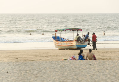 People on beach against sea