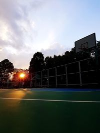 Scenic view of soccer field against sky during sunset